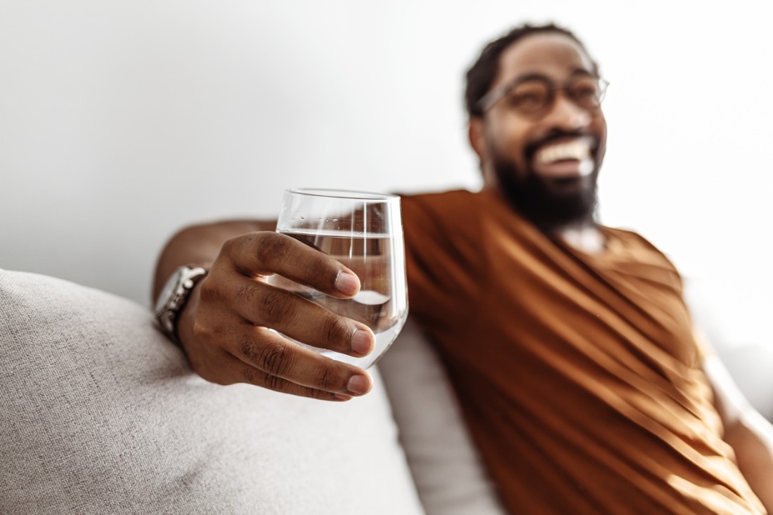  A photo of man holding a glass of water