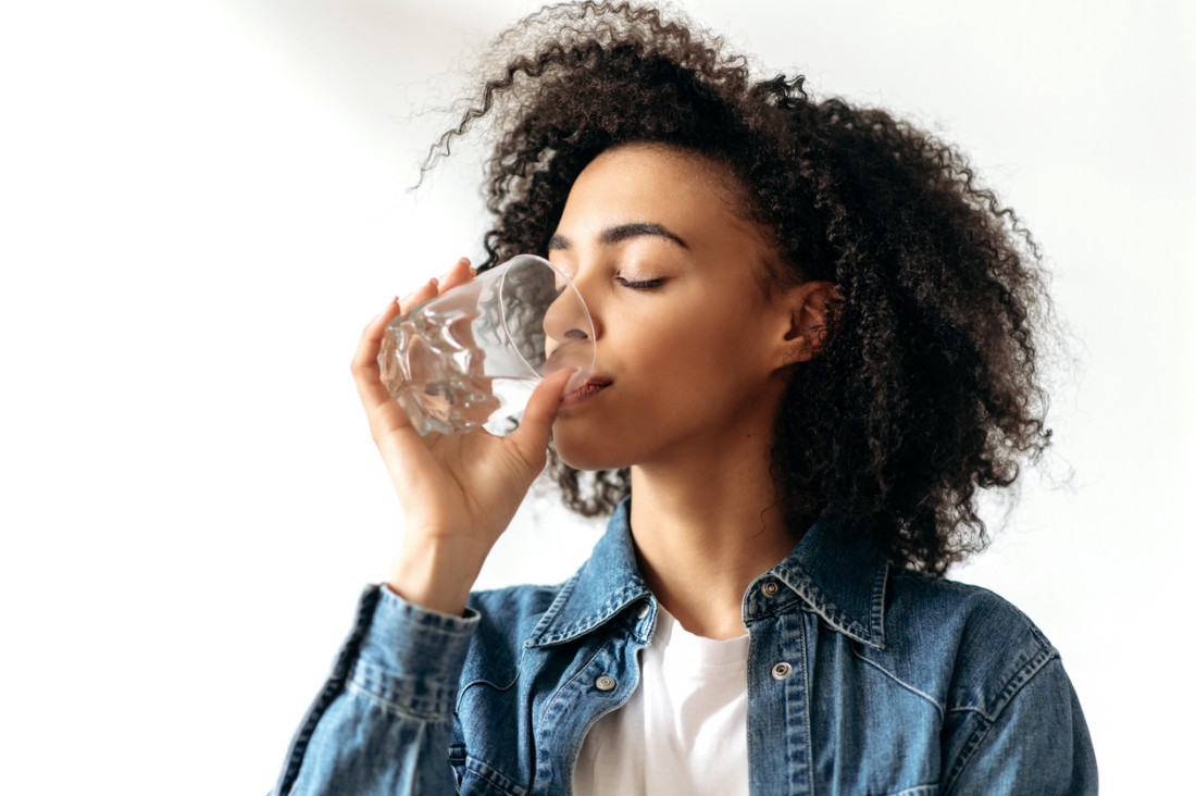 Photo of a woman drinking a glass of water