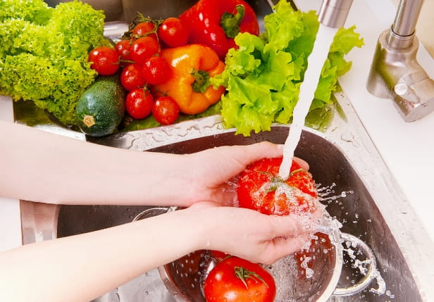 A photo of a hand holding a tomatoes
