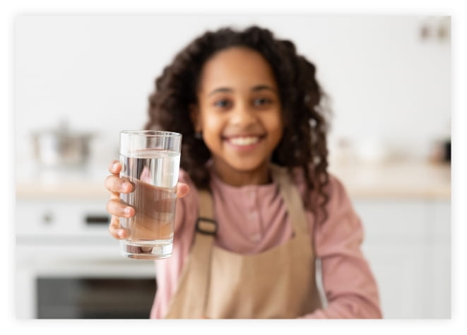 A girl holding a glass of water